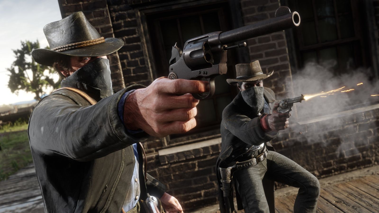 In-game image from Red Dead Redemption 2 of two characters wearing cowboy hats with their faces covered firing pistols.